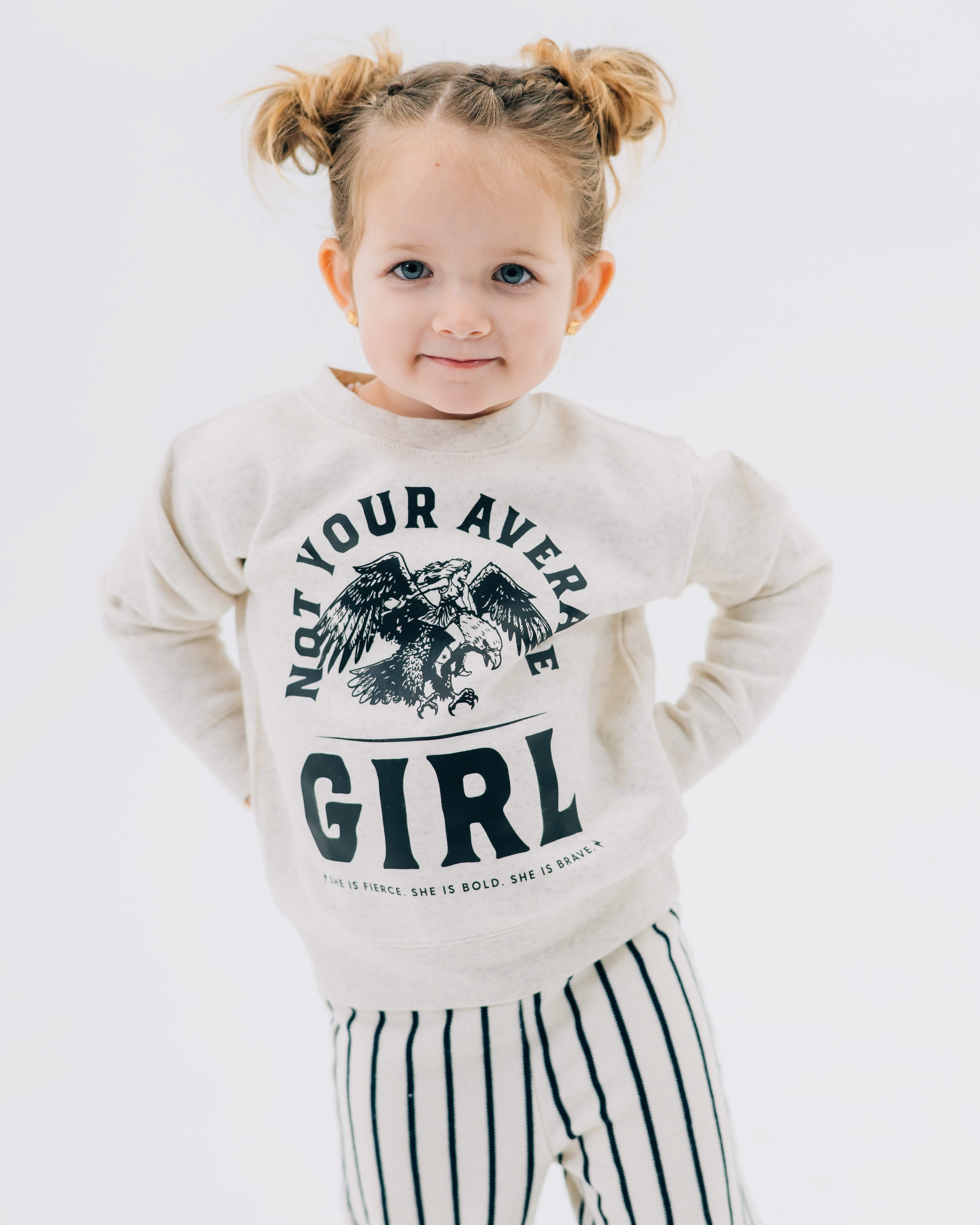Child sweater in natural with "Not Your Average" design on front, shown on model – Little Mama Shirt Shop