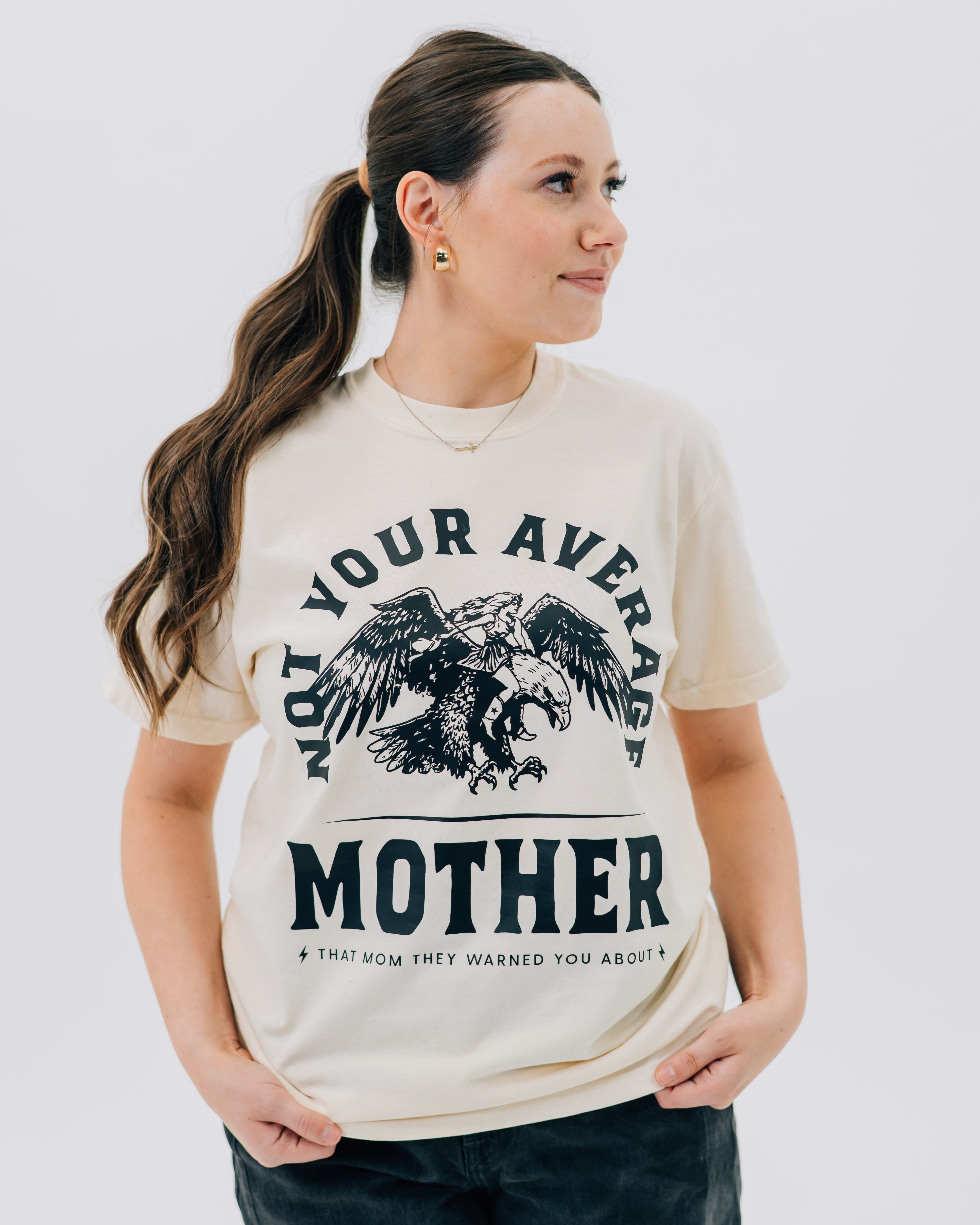 Adult tee in ivory with "Not Your Average" design on front, shown on model – Little Mama Shirt Shop