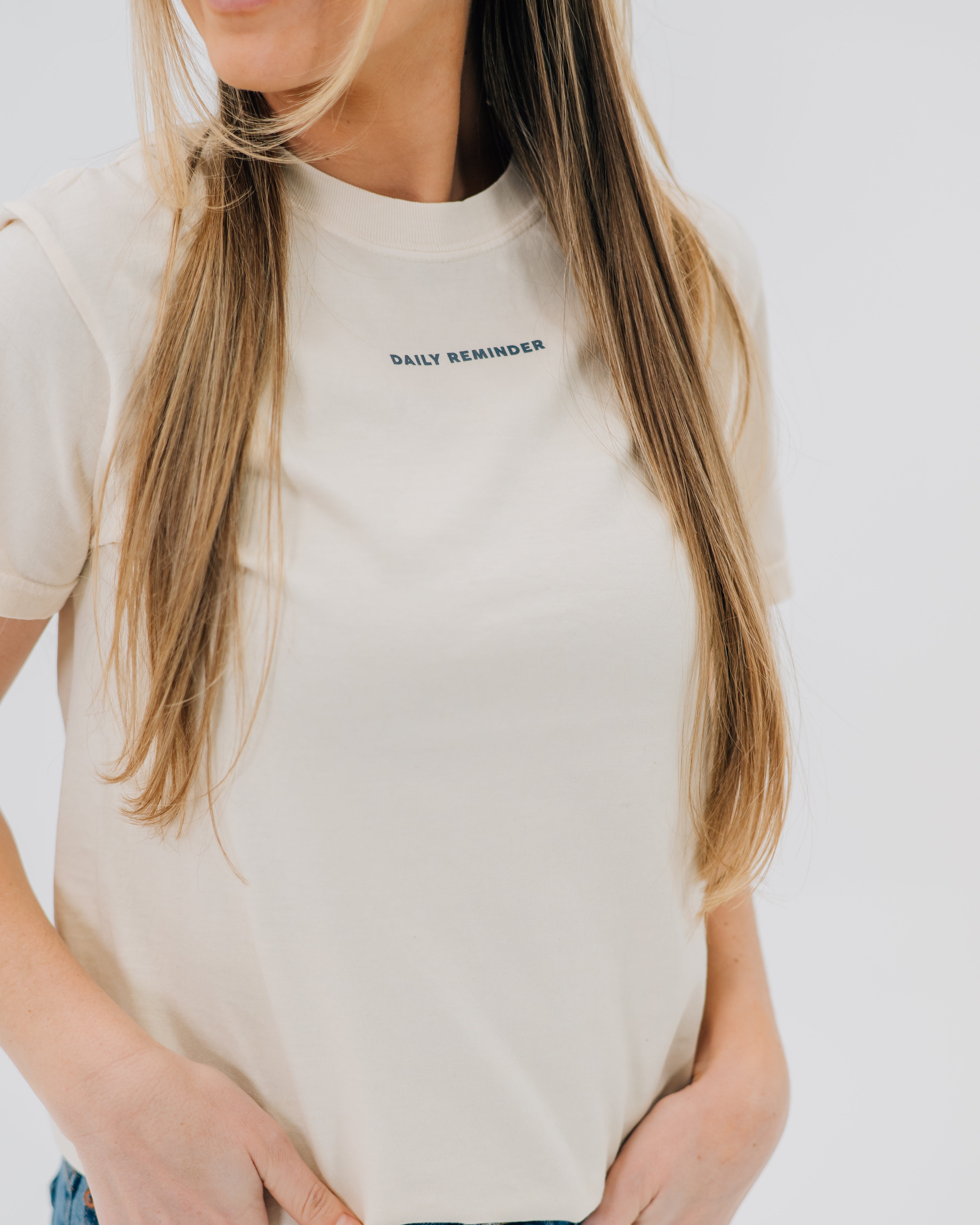 Ivory comfort colors tee with "daily reminder" printed on front chest, seen on model - Little Mama Shirt Shop