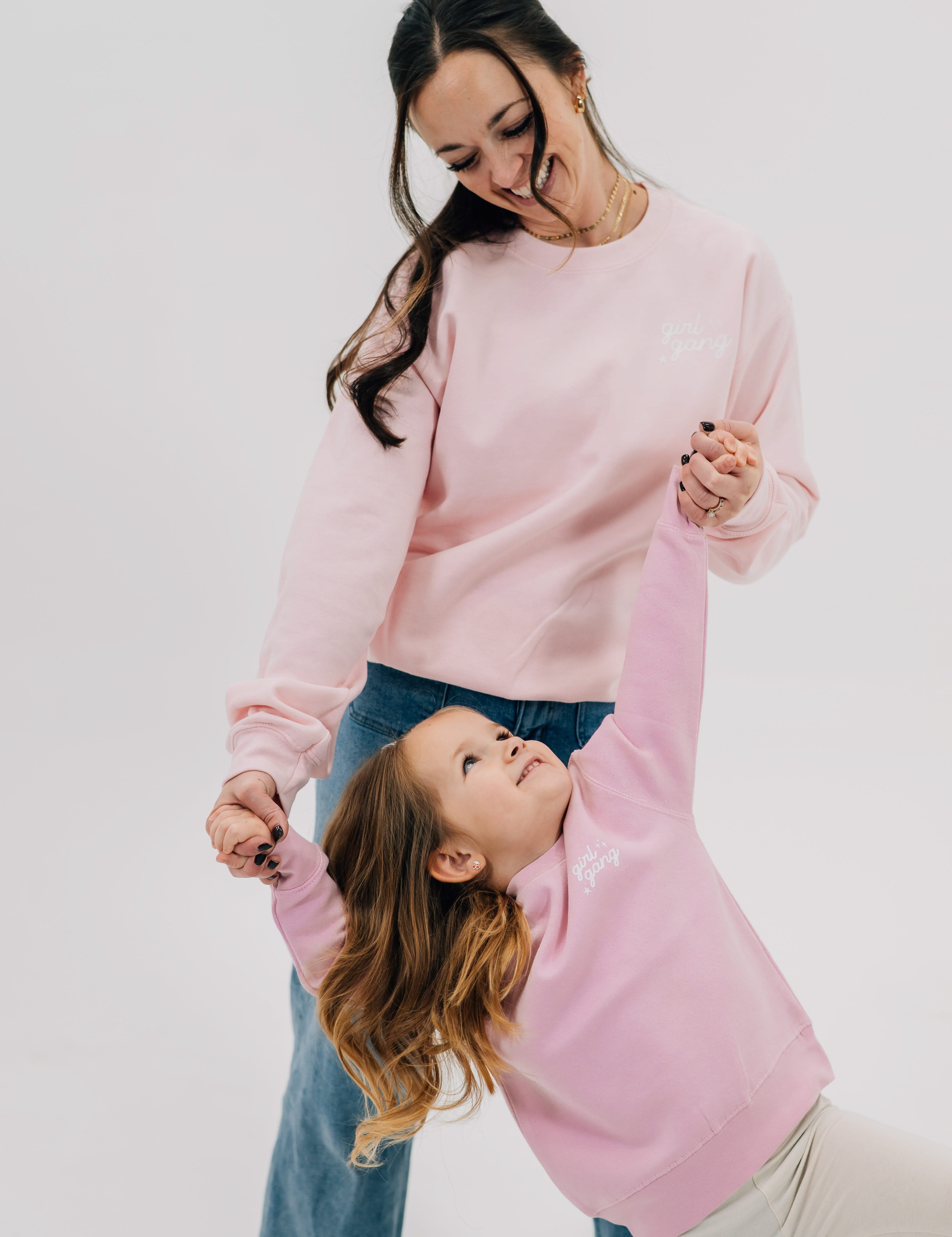 Adult and child sweaters in light pink with "girl gang" design on front chest, shown on models - Little Mama Shirt Shop