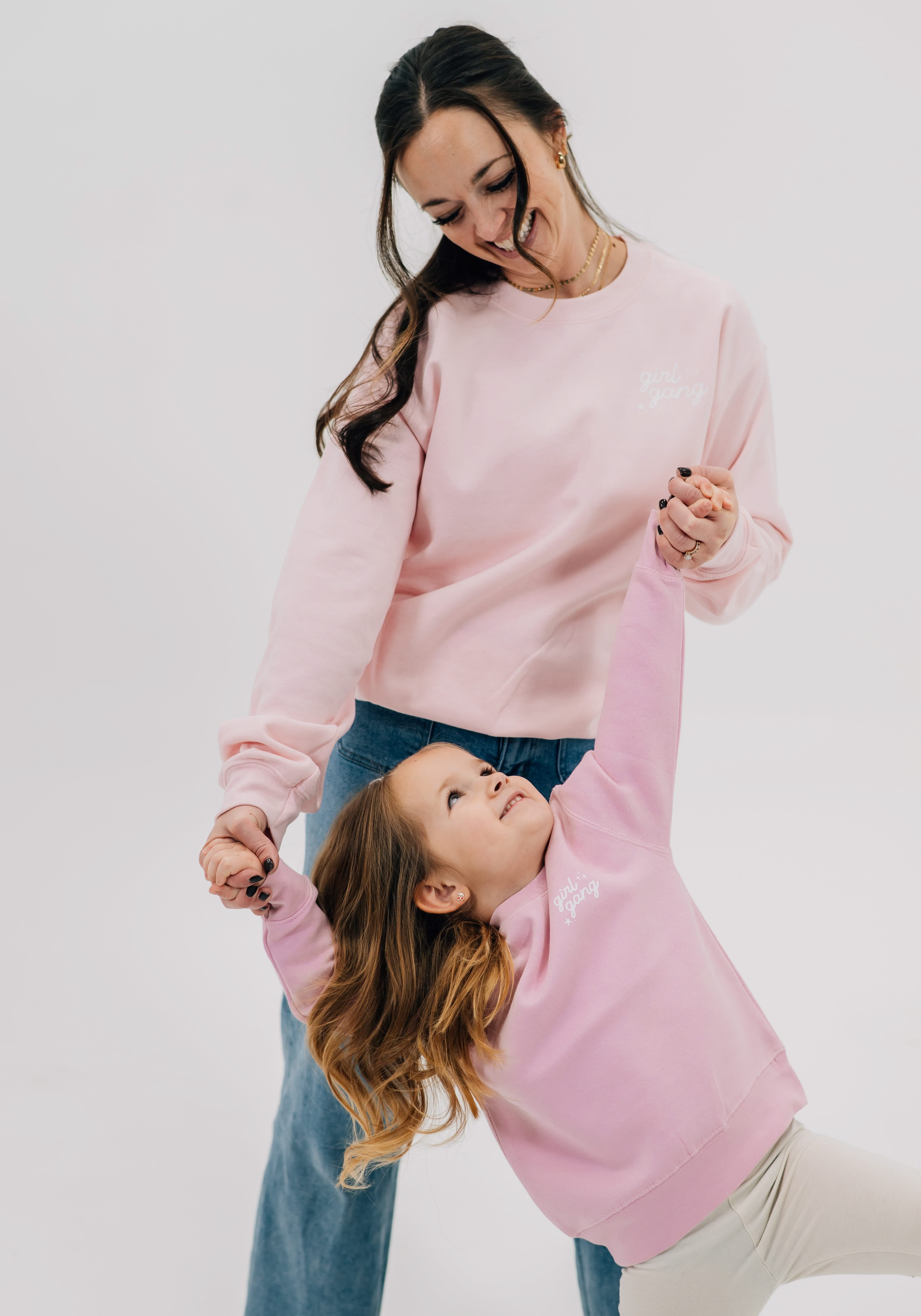 Adult and child sweaters in light pink with "girl gang" design on front chest, shown on models - Little Mama Shirt Shop