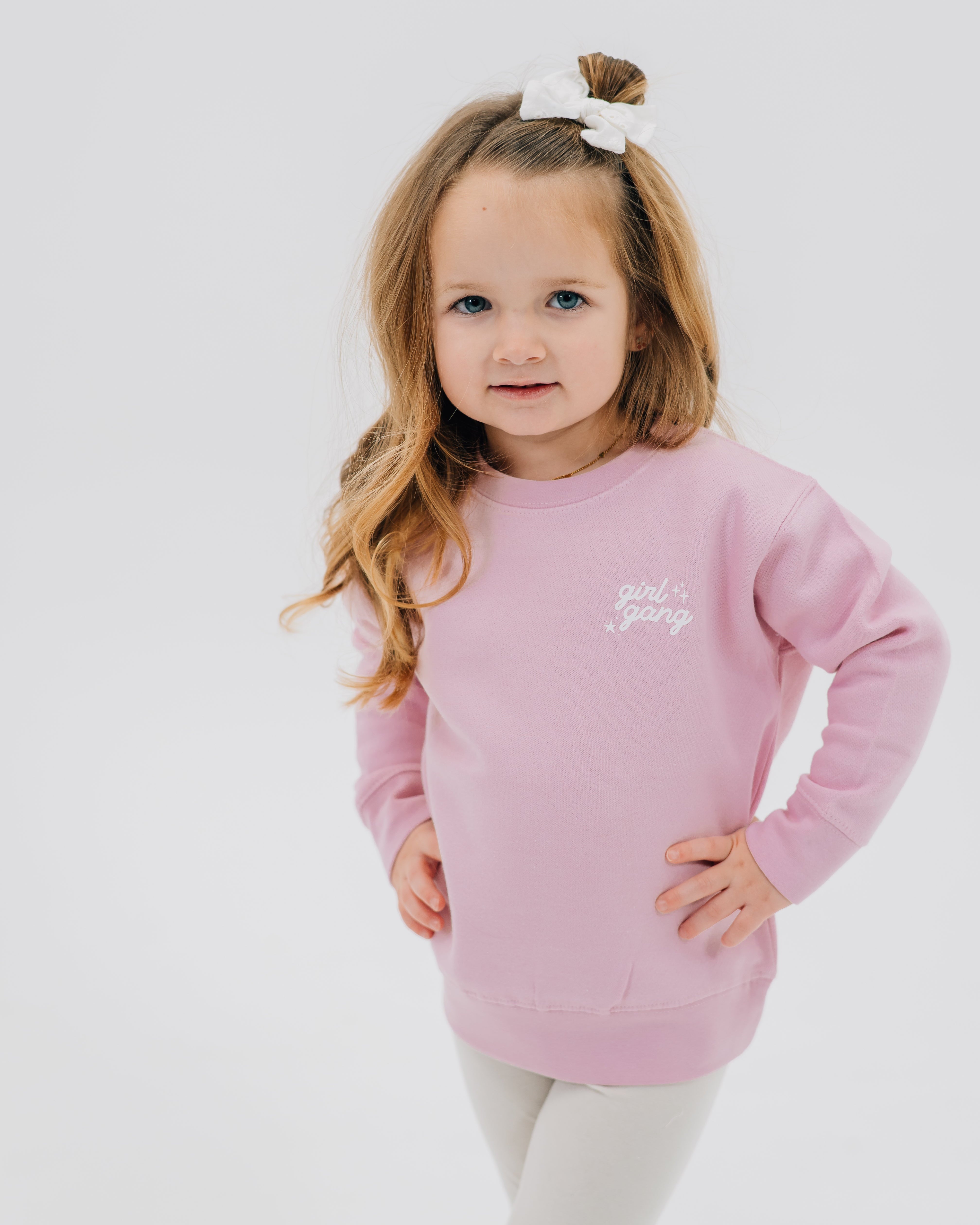 Child sweater in light pink with "girl gang" design on front chest, shown on model - Little Mama Shirt Shop