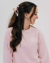Adult sweater in light pink with "girl gang" design on front chest, shown on model - Little Mama Shirt Shop