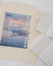 Ivory comfort colors tee with permission to be cloud graphic on back, seen on flat lay - Little Mama Shirt Shop