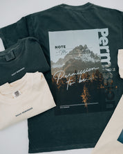 Pepper comfort colors tee with permission to be mountain graphic on back and daily reminder printed on front, seen on flat lay - Little Mama Shirt Shop