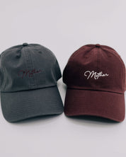 Gray hat with maroon and maroon hat with cream embroidery "Mother", seen on flat lay - Little Mama Shirt Shop