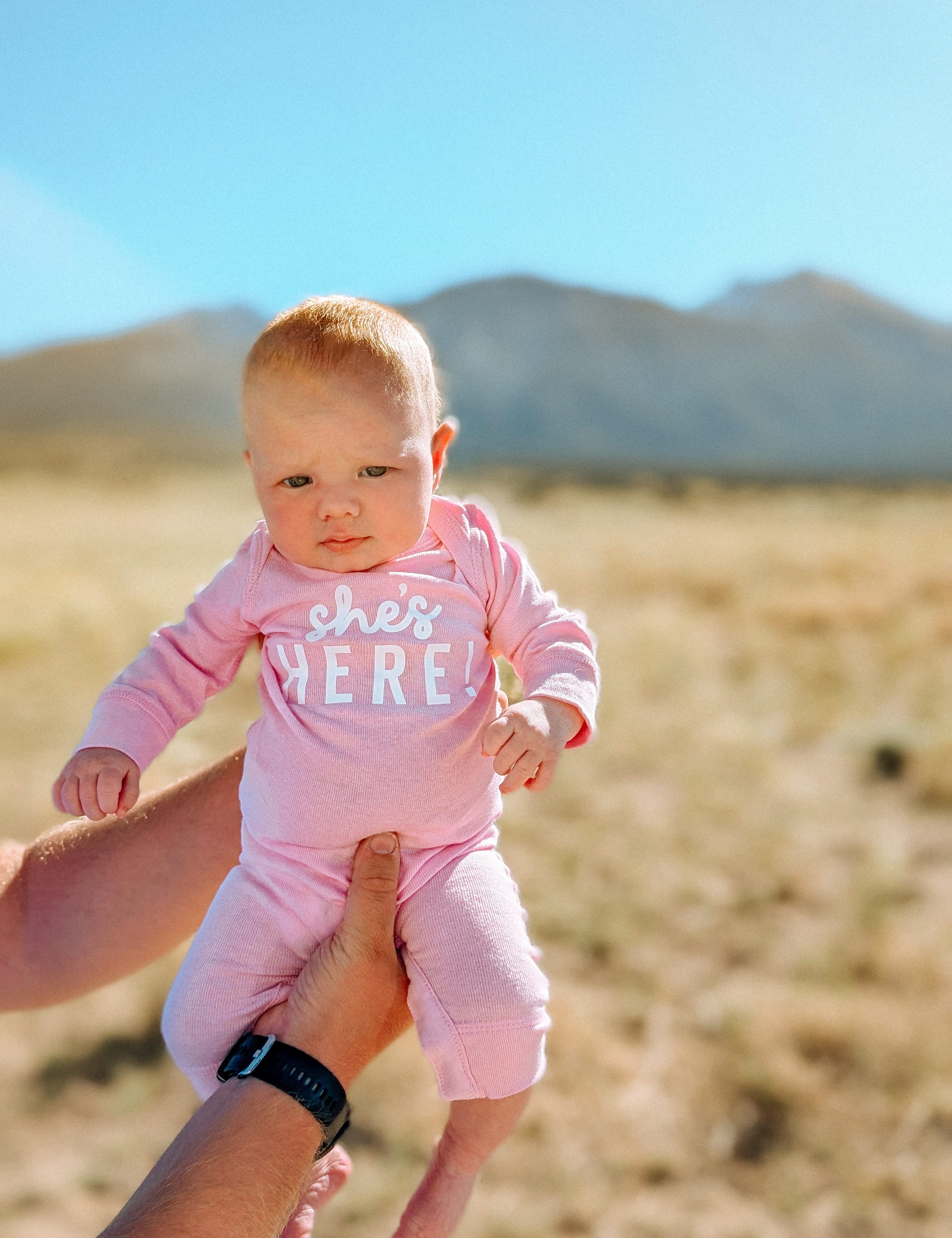 SHE'S HERE! - One Piece Baby Sleeper Little Mama Shirt Shop