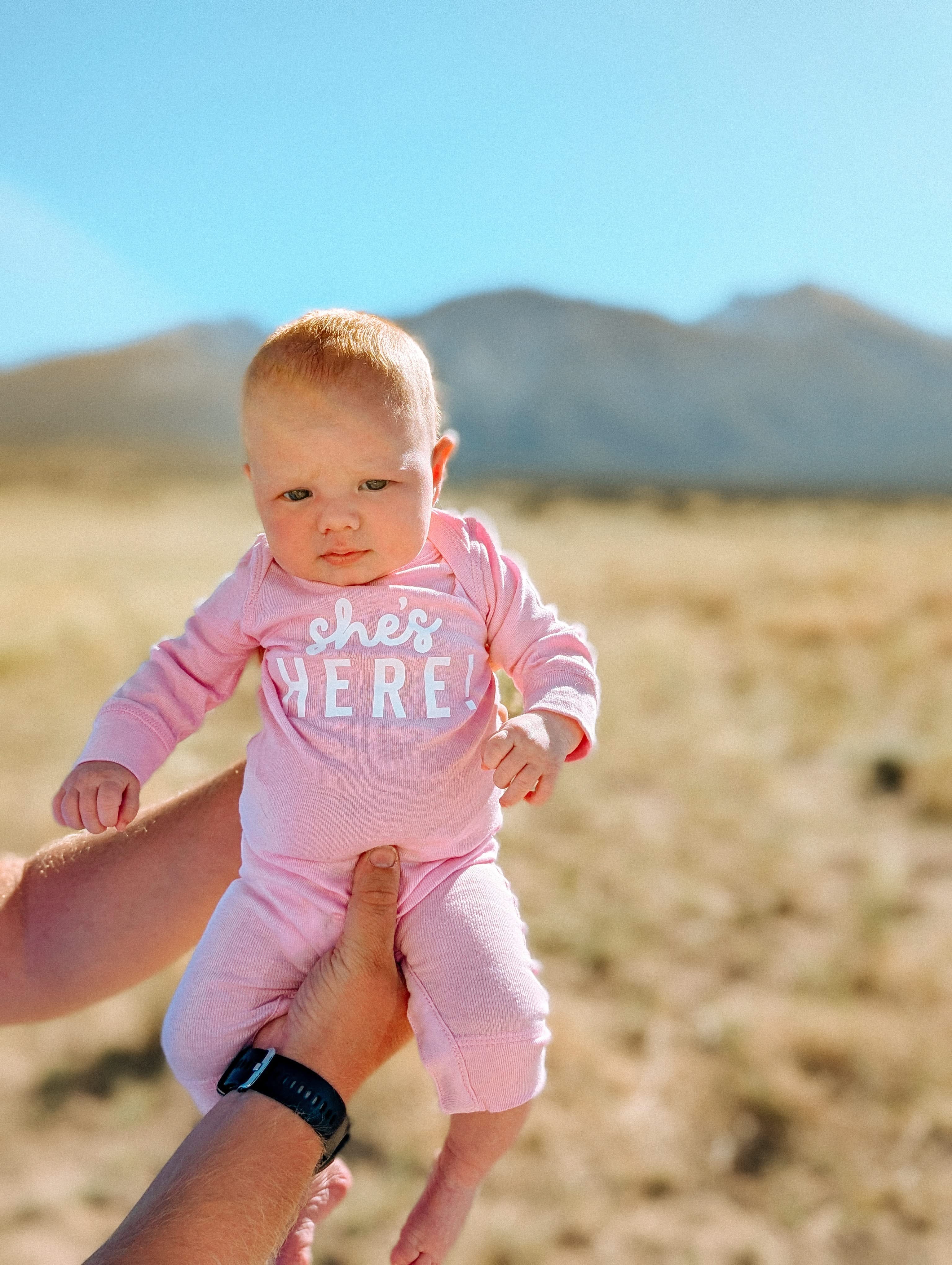 SHE'S HERE! - One Piece Baby Sleeper Little Mama Shirt Shop