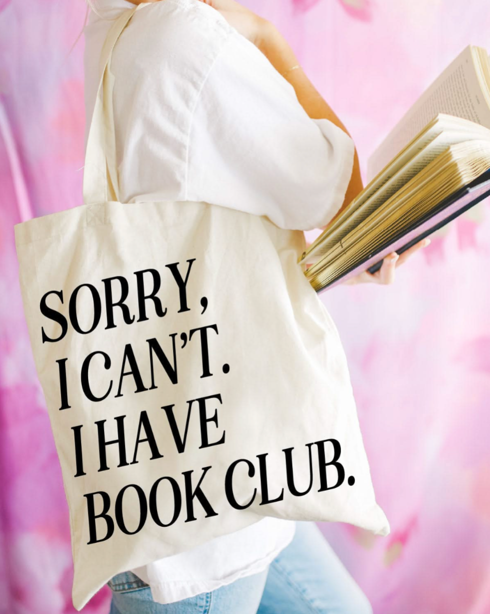 Beige canvas tote bag featuring a 'Sorry, I can't. I have book club.' design on a model - Little Mama Shirt Shop