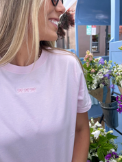 Adult tee in soft pink with mini symbol three bows design on front, shown on model – Little Mama Shirt Shop