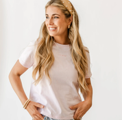 Adult tee in soft pink with mini symbol three bows design on front, shown on model – Little Mama Shirt Shop