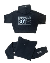 Hoodie front and back view in black with white 'Raising My Boy' graphic on flat lay - Little Mama Shirt Shop