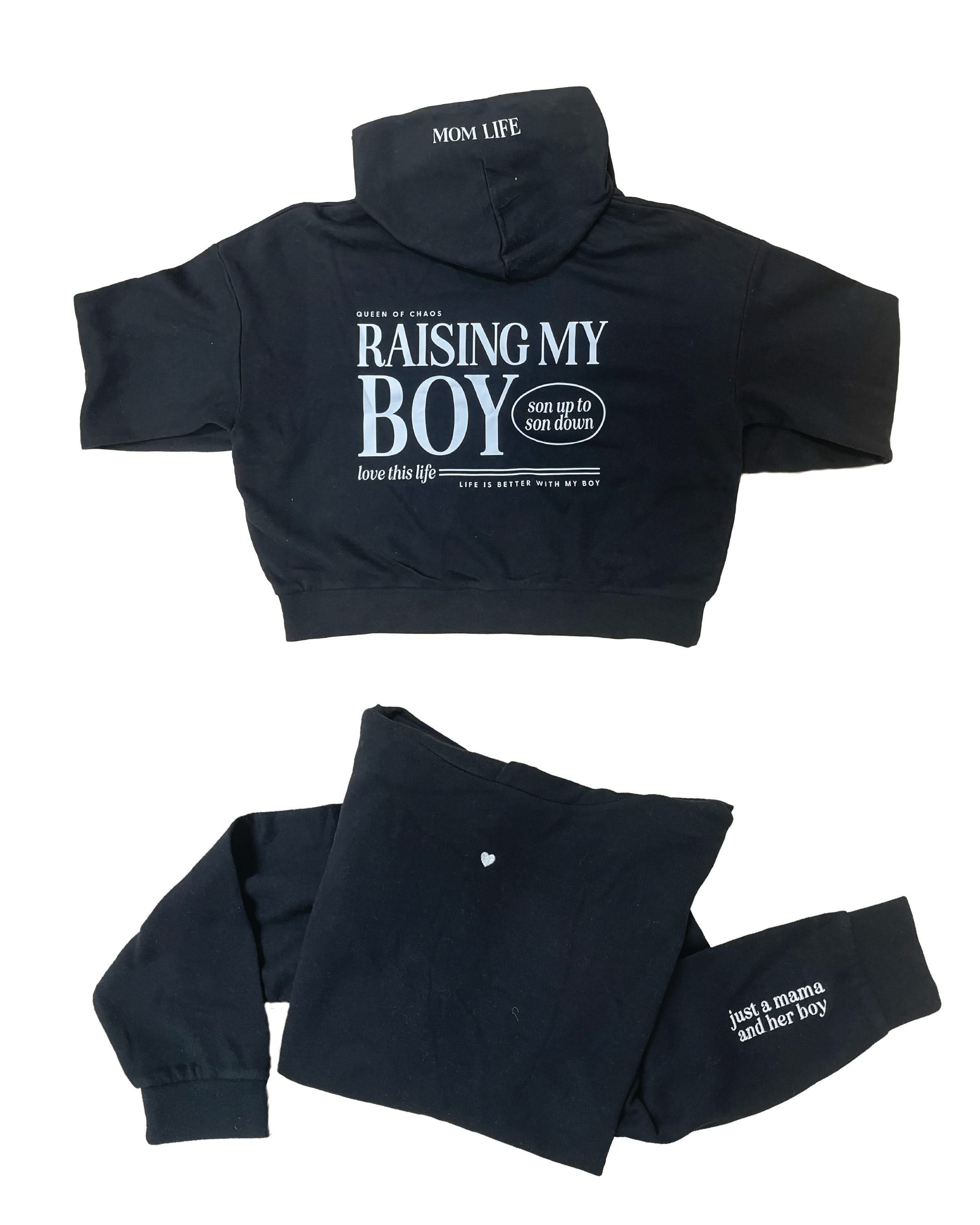 Hoodie front and back view in black with white 'Raising My Boy' graphic on flat lay - Little Mama Shirt Shop