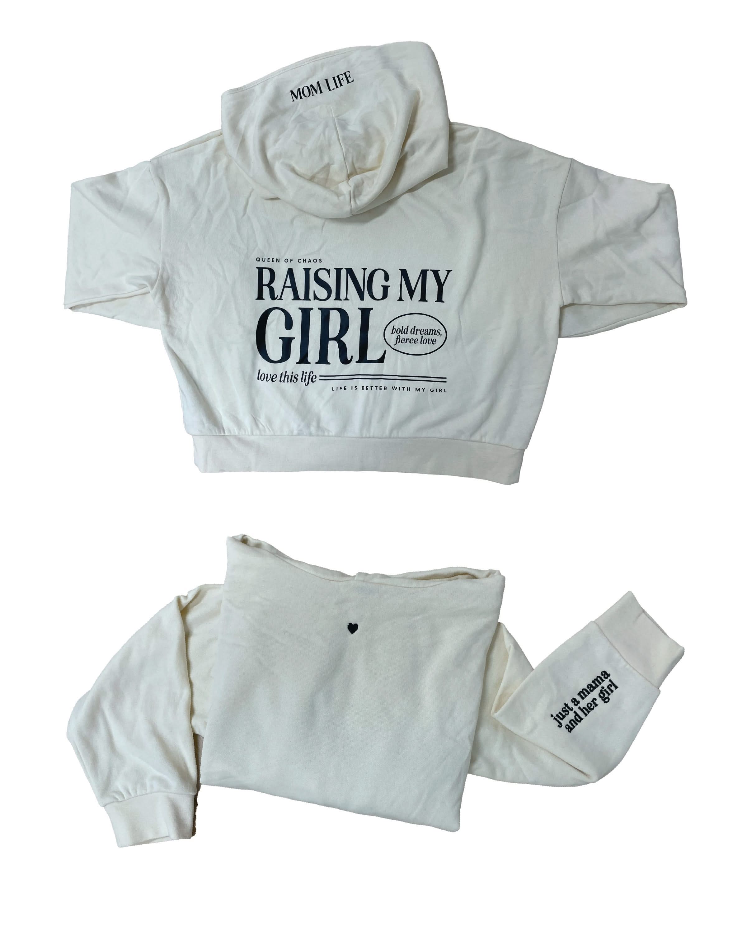 Hoodie front and back view in bone with black 'Raising My Girl' graphic on flat lay - Little Mama Shirt Shop