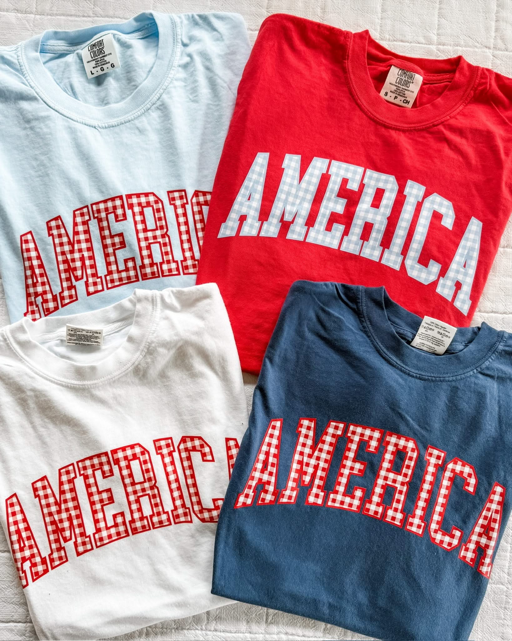 AMERICA shirts in soft red, blue, and white tones with gingham print, styled together for a patriotic summer look