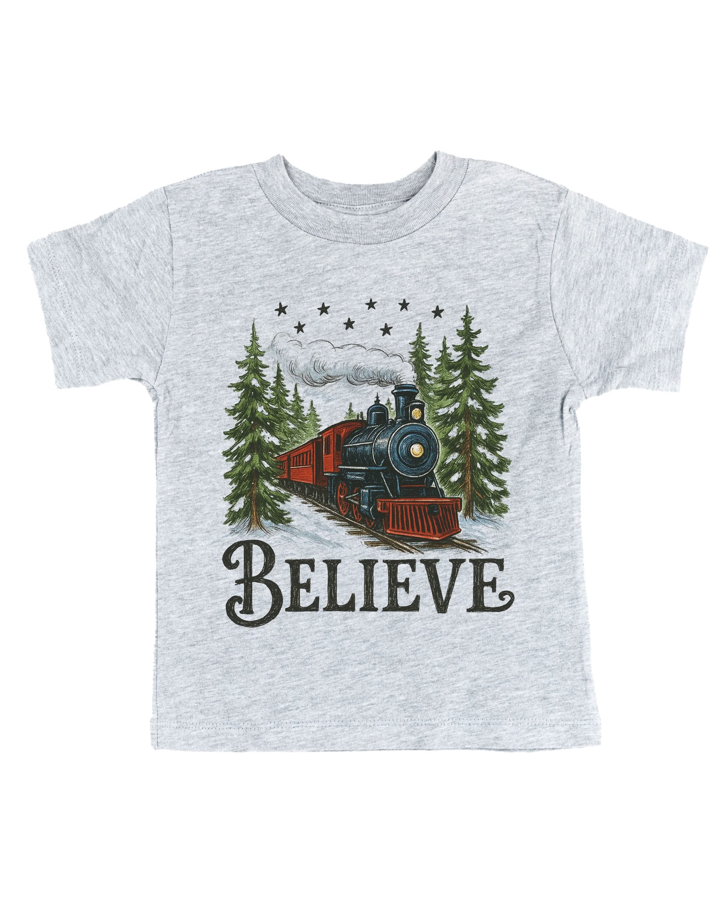 Child tee in gray with winter train and 'Believe' on chest, shown on flat lay – Little Mama Shirt Shop