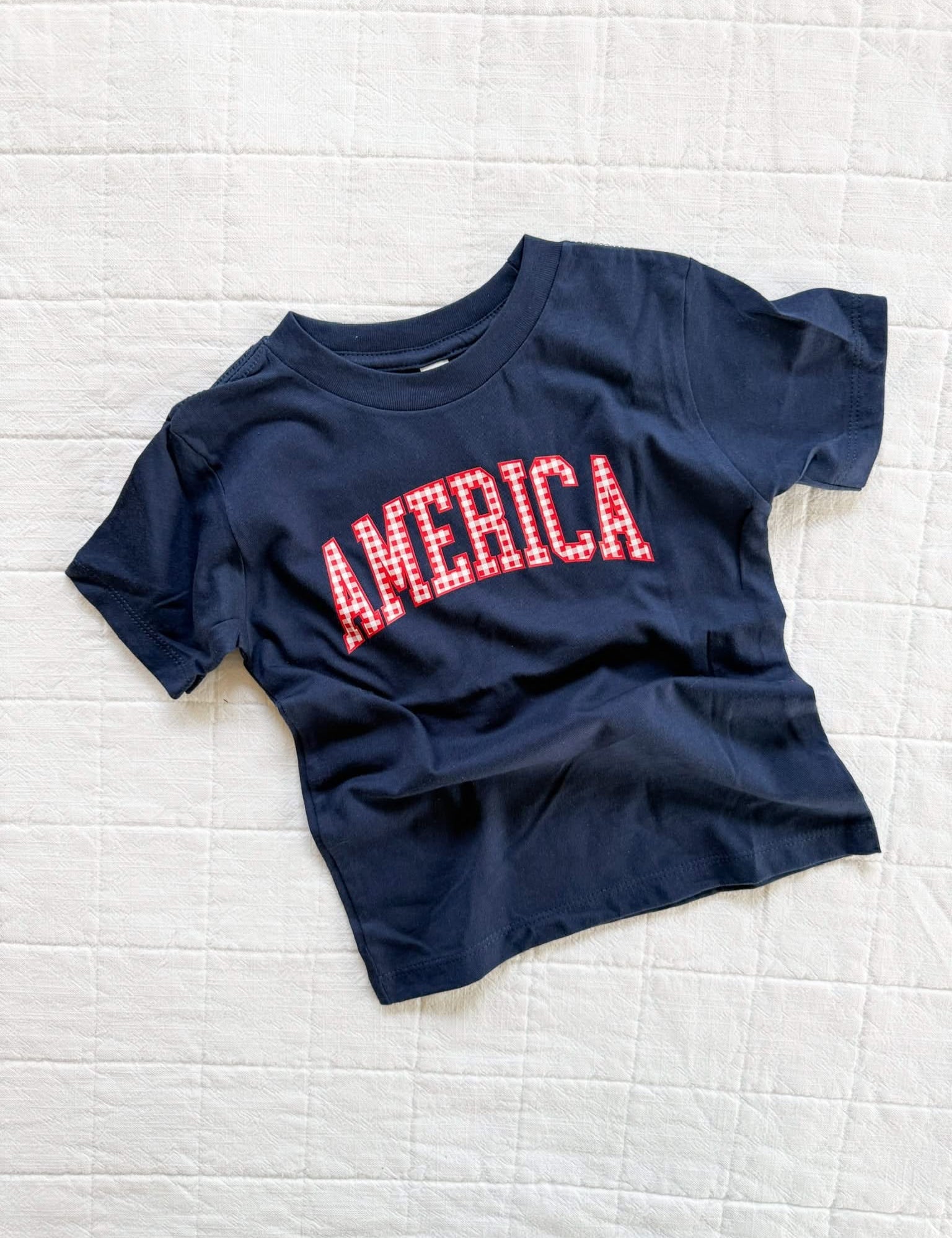 Blue AMERICA shirt for kids with gingham lettering, easy everyday style for summer