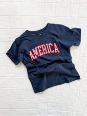 Blue AMERICA shirt for kids with gingham lettering, easy everyday style for summer
