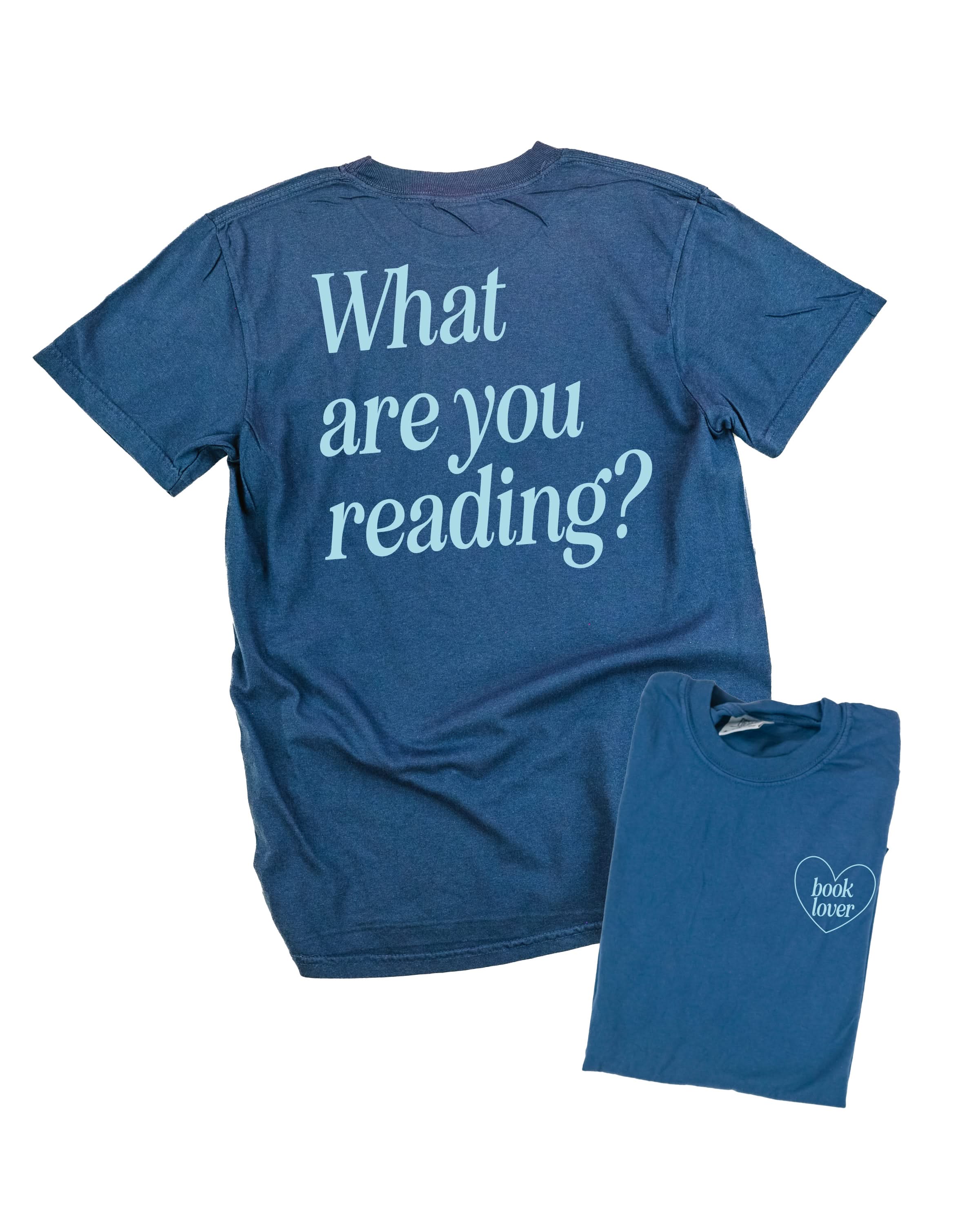  light blue detail with a 'book lover' heart graphic on the front and 'What are you reading?' graphic on back, shown on flat lay – Little Mama Shirt Shop