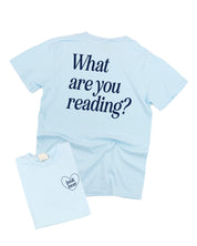 Comfort colors tee in chambray w/ navy detail with a 'book lover' heart graphic on the front and 'What are you reading?' graphic on back, shown on flat lay – Little Mama Shirt Shop