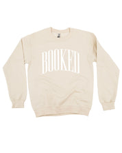 Basic fleece in sand with 'BOOKED' graphic on chest, shown on flat lay – Little Mama Shirt Shop