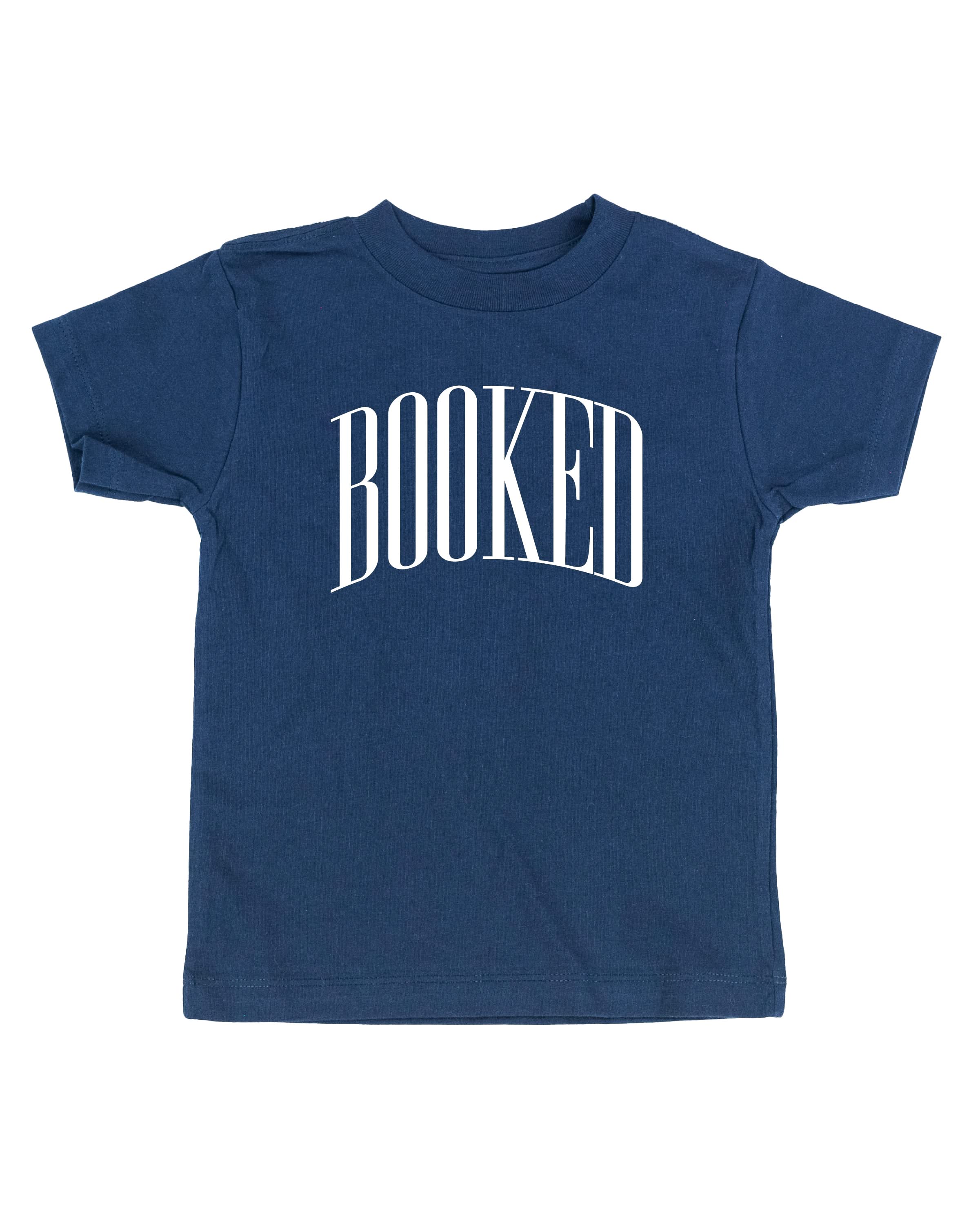 Child tee in navy with 'BOOKED' graphic on chest, shown on flat lay – Little Mama Shirt Shop