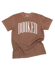 Comfort colors tee in espresso with 'BOOKED' graphic on chest, shown on flat lay – Little Mama Shirt Shop