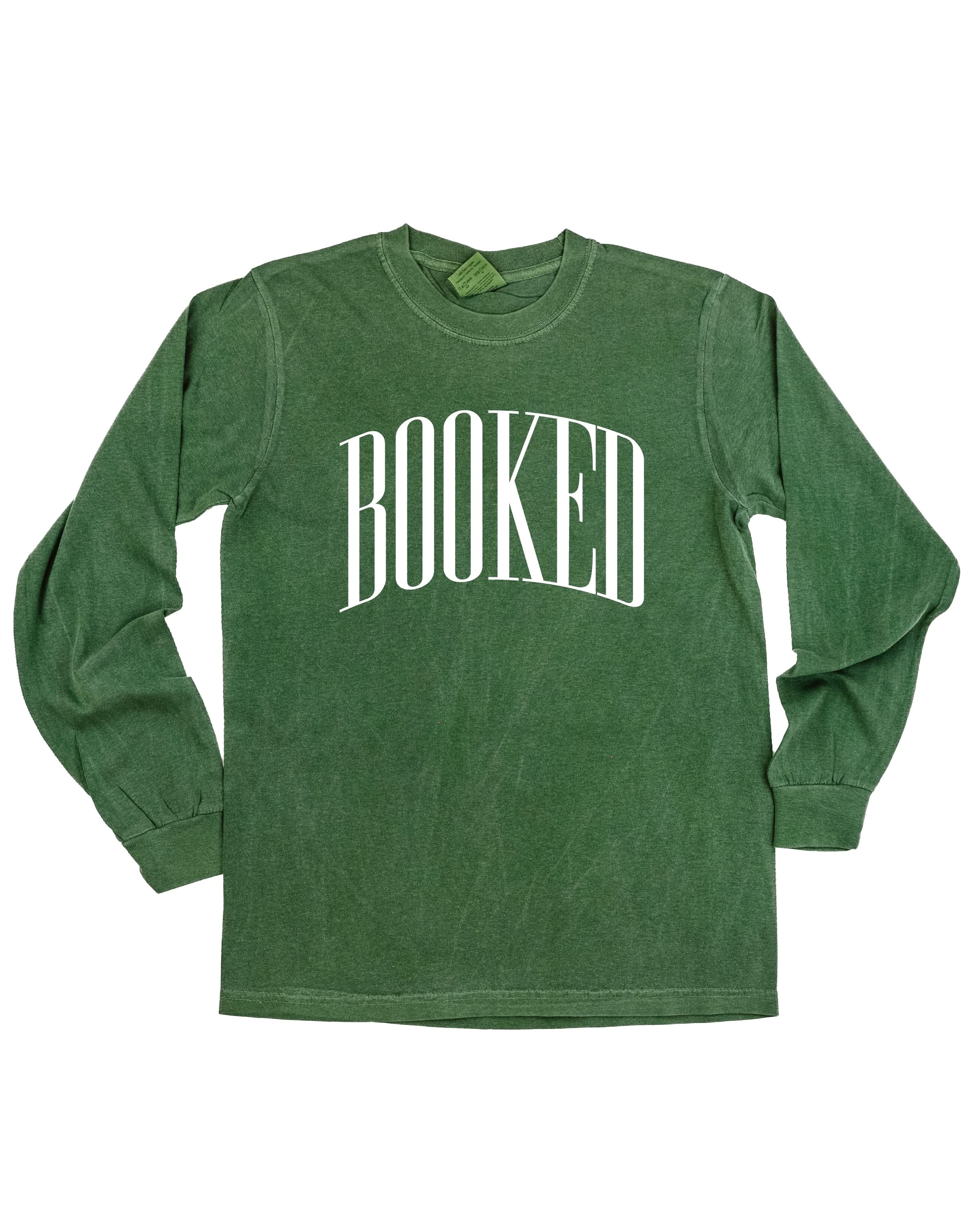 Long sleeve comfort colors tee in hemp with 'BOOKED' graphic on chest, shown on flat lay – Little Mama Shirt Shop