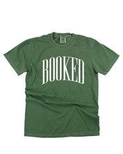 Comfort colors tee in hemp with 'BOOKED' graphic on chest, shown on flat lay – Little Mama Shirt Shop