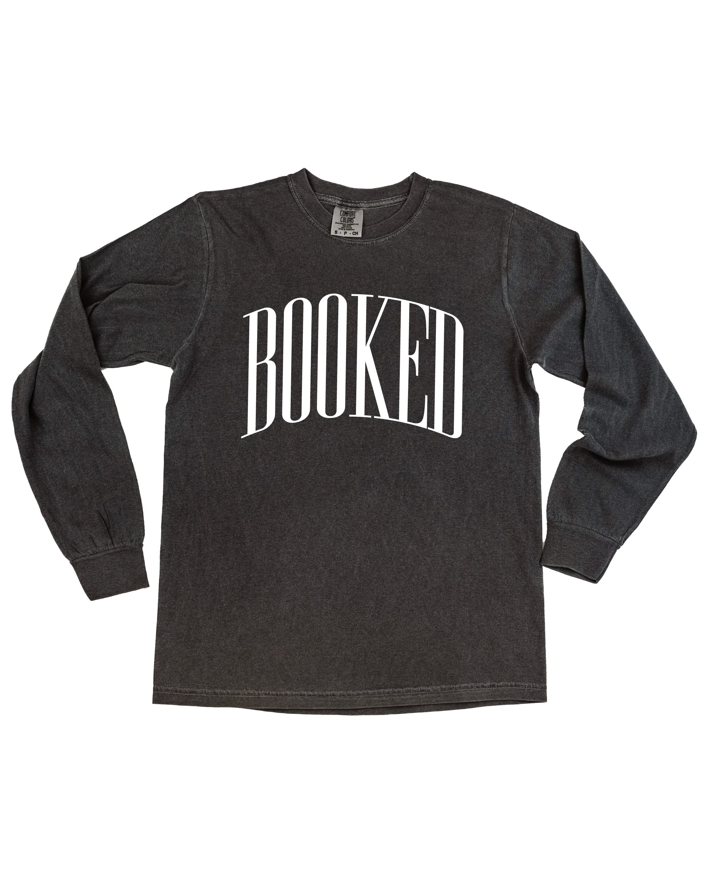 Long sleeve comfort colors tee in pepper with 'BOOKED' graphic on chest, shown on flat lay – Little Mama Shirt Shop