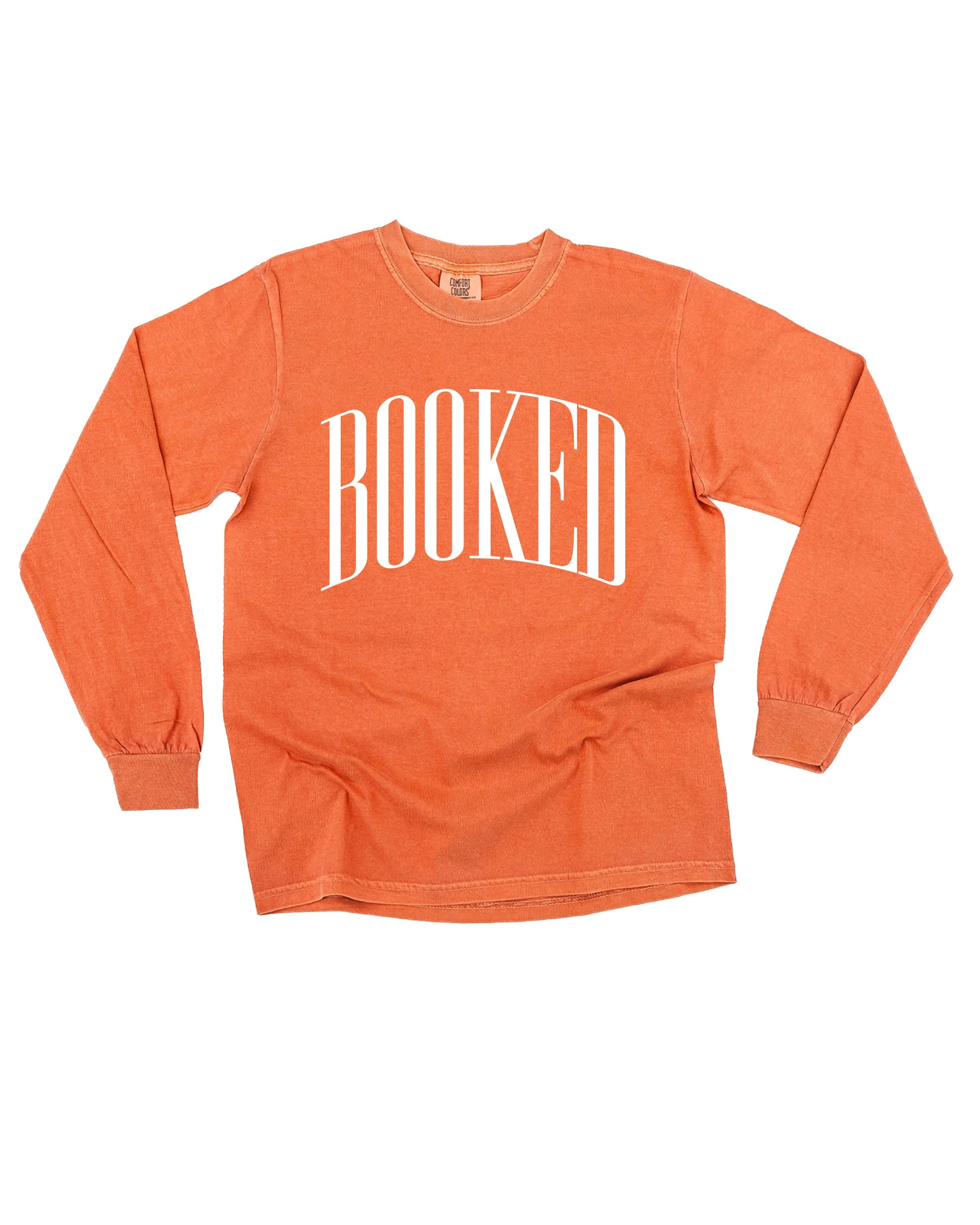 Long sleeve comfort colors tee in yam with 'BOOKED' graphic on chest, shown on flat lay – Little Mama Shirt Shop