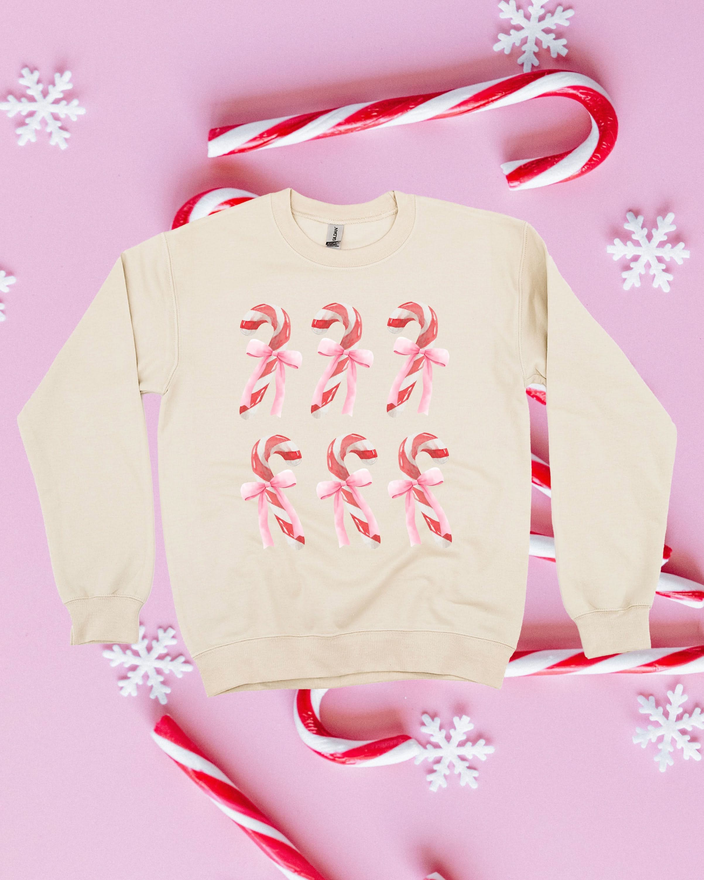 Adult Sweater in sand with 6 candy canes on chest, shown on flat lay – Little Mama Shirt Shop