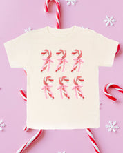 Child tee in natural with 6 candy canes on chest, shown on flat lay – Little Mama Shirt Shop