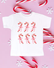 Child tee in white with 6 candy canes on chest, shown on flat lay – Little Mama Shirt Shop
