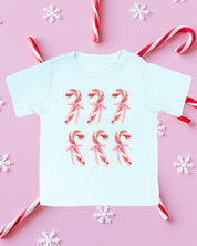 Child tee in ice blue with 6 candy canes on chest, shown on flat lay – Little Mama Shirt Shop