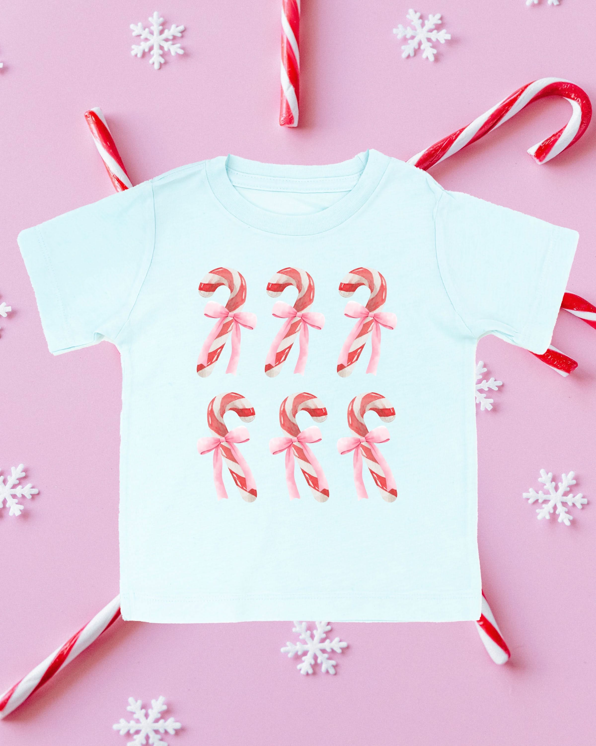 Child tee in ice blue with 6 candy canes on chest, shown on flat lay – Little Mama Shirt Shop