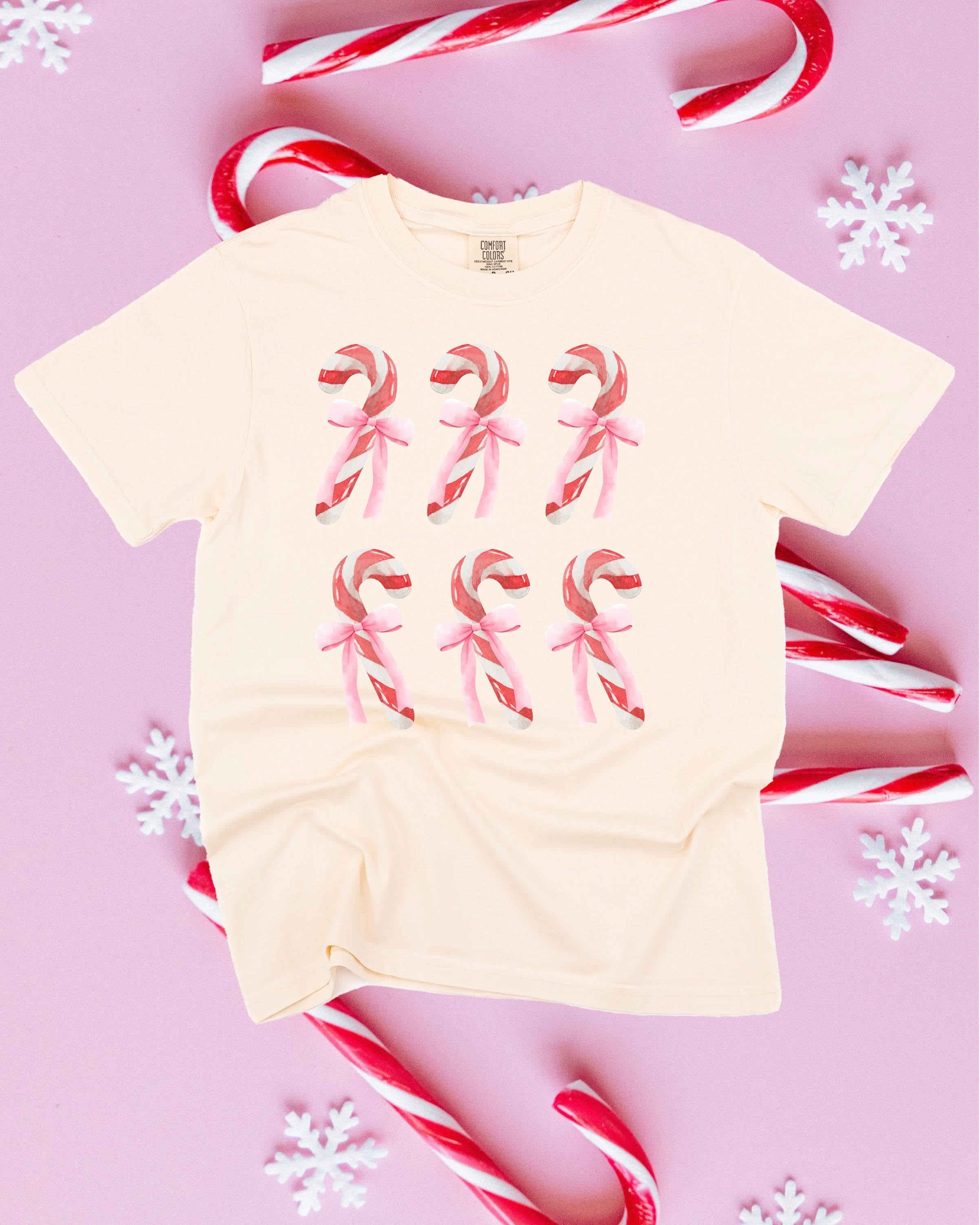 Comfort Colors Tee in ivory with 6 candy canes on chest, shown on flat lay – Little Mama Shirt Shop