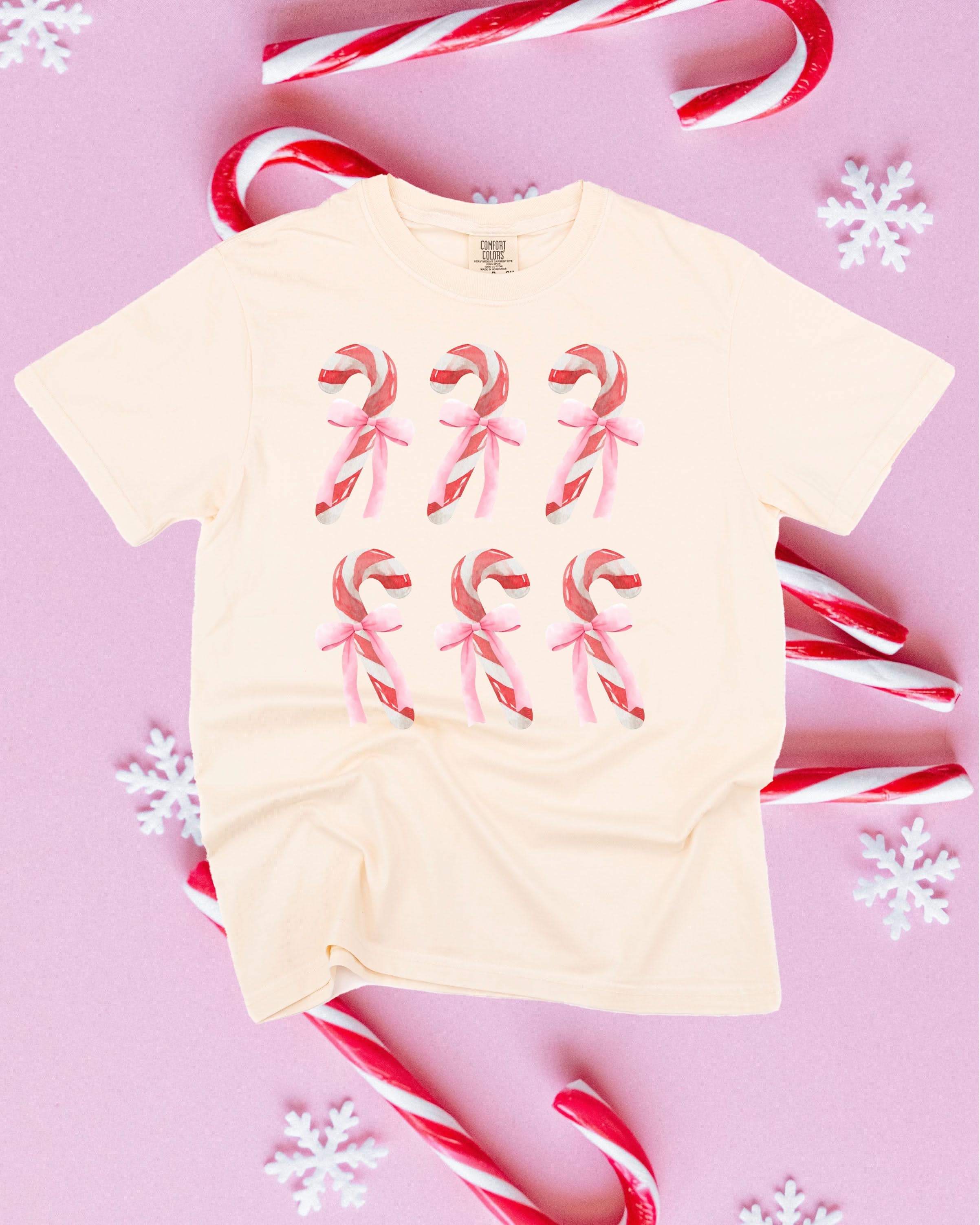 Comfort Colors Tee in ivory with 6 candy canes on chest, shown on flat lay – Little Mama Shirt Shop