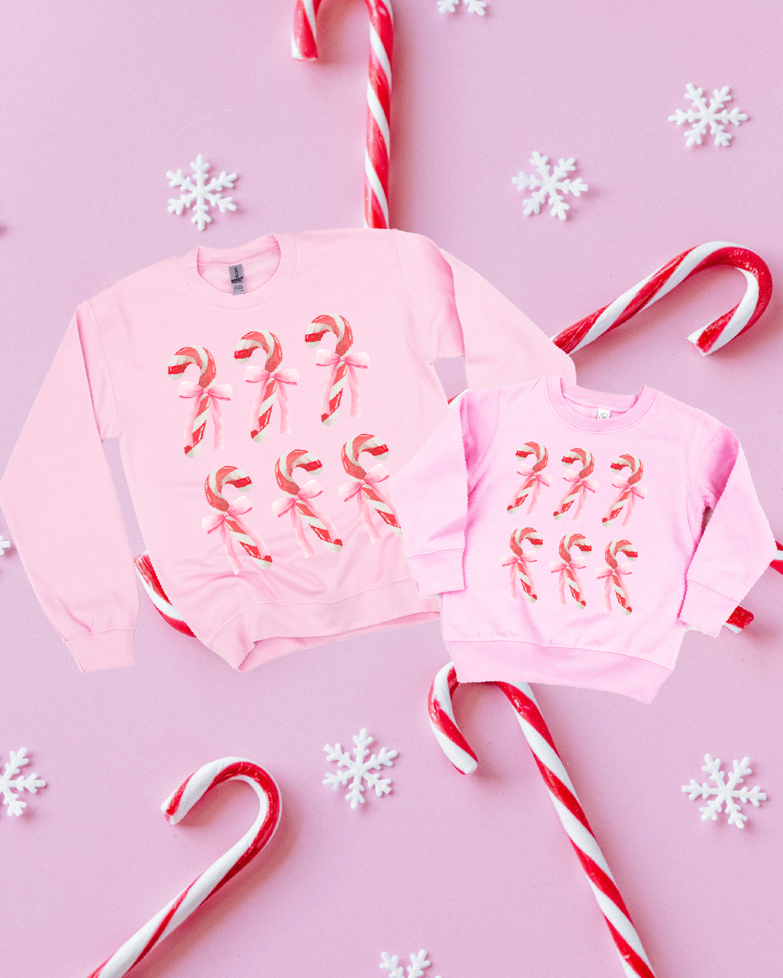 Adult and Child sweaters in white with 6 candy canes on chest, shown on flat lay – Little Mama Shirt Shop