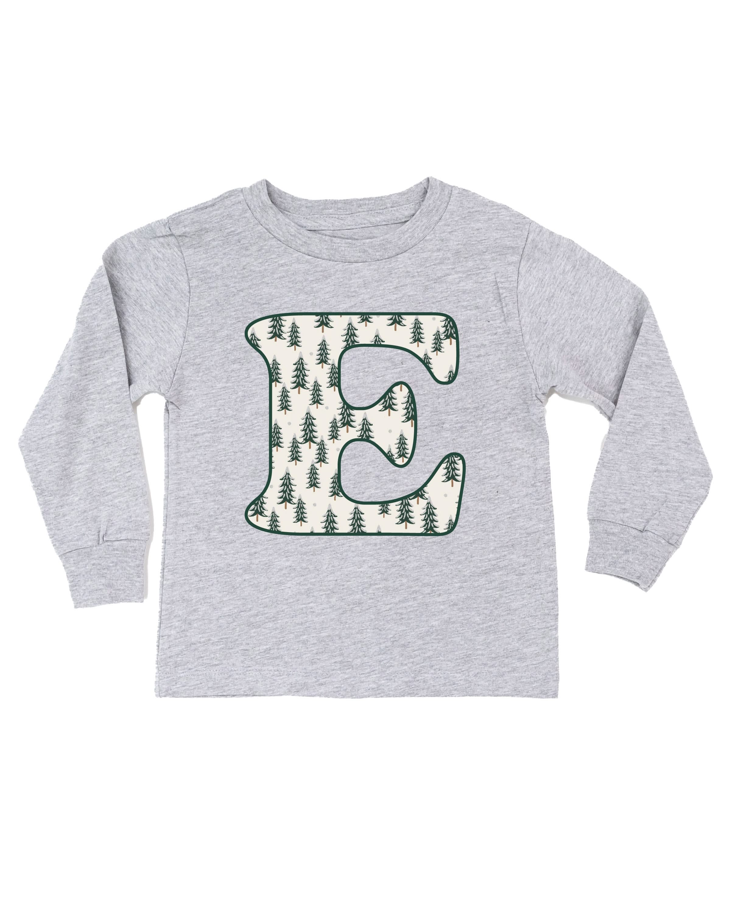 Child long sleeve in white with Christmas patterned trees initial E on front, shown on flat lay – Little Mama Shirt Shop