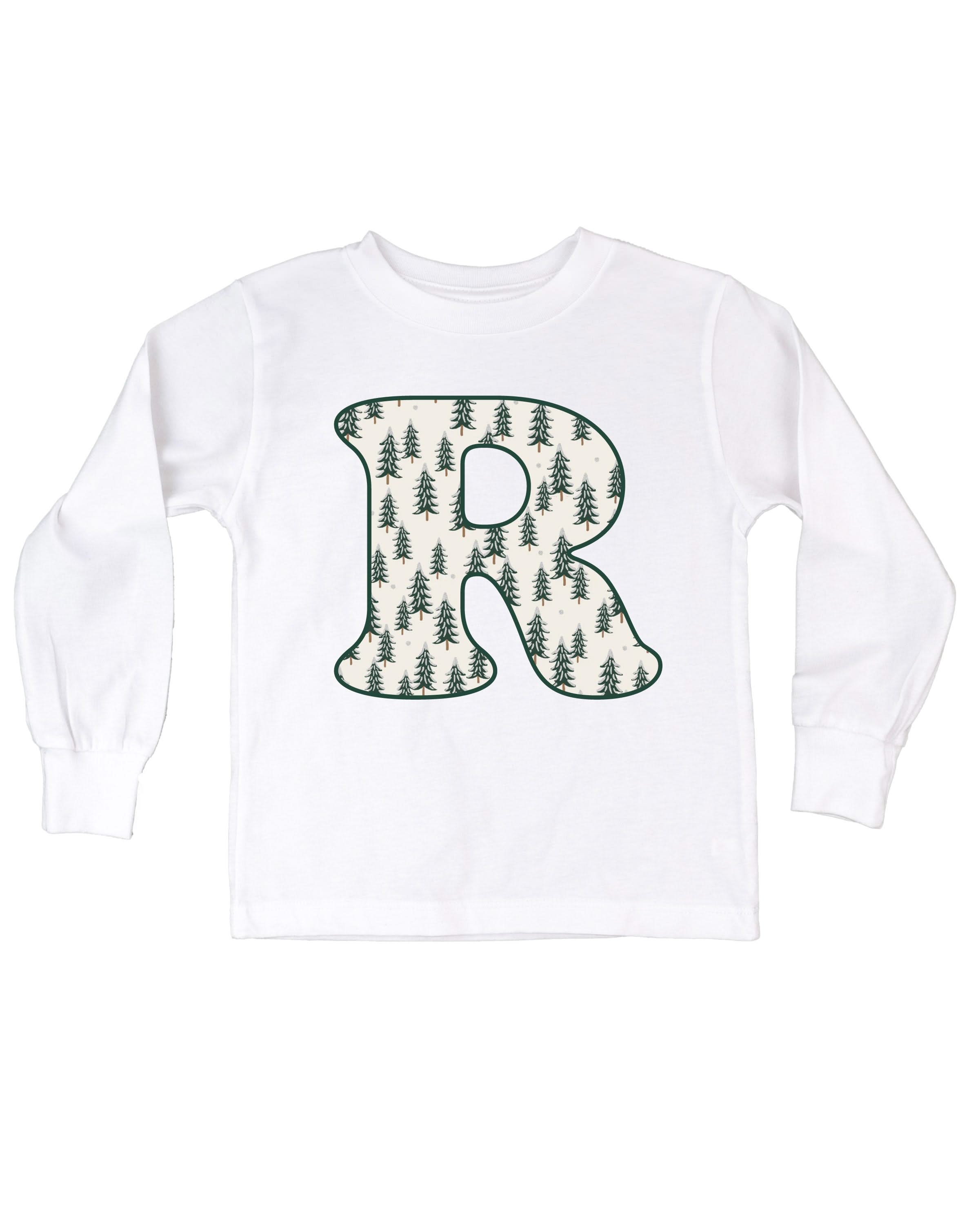 Child long sleeve in white with Christmas patterned trees initial R on front, shown on flat lay – Little Mama Shirt Shop