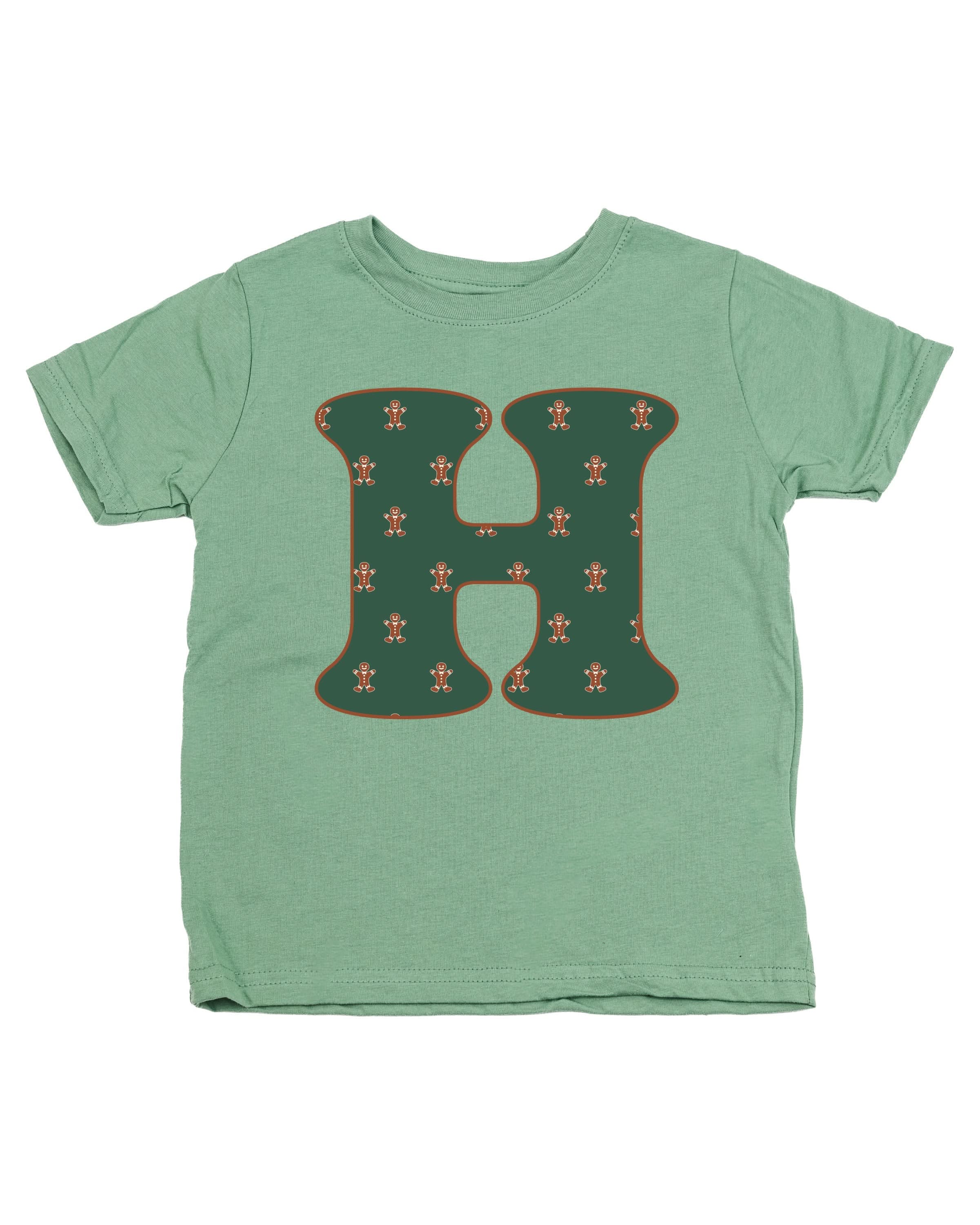 Child tee in sage with Christmas pattern gingerbread men with initial H on front, shown on flat lay – Little Mama Shirt Shop