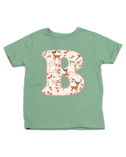 Child tee in sage with Christmas pattern reindeer with initial B on front, shown on flat lay – Little Mama Shirt Shop