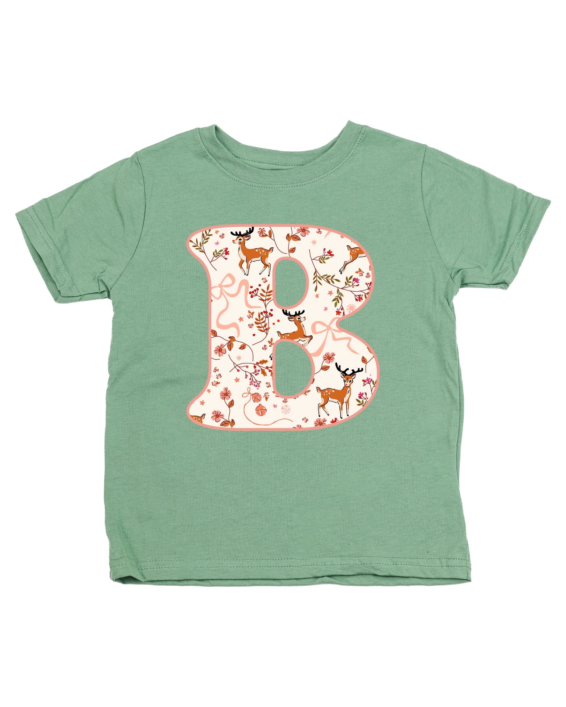 Child tee in sage with Christmas pattern reindeer with initial B on front, shown on flat lay – Little Mama Shirt Shop
