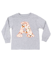 Child long sleeve in white with Christmas patterned reindeer initial A on front, shown on flat lay – Little Mama Shirt Shop