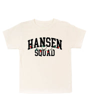  Child short sleeve in natural with personalized last name printed on front with Christmas lights under, shown on flat lay – Little Mama Shirt Shop