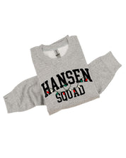 Adult basic fleece in gray with personalized last name printed on front with Christmas lights under, shown on flat lay – Little Mama Shirt Shop