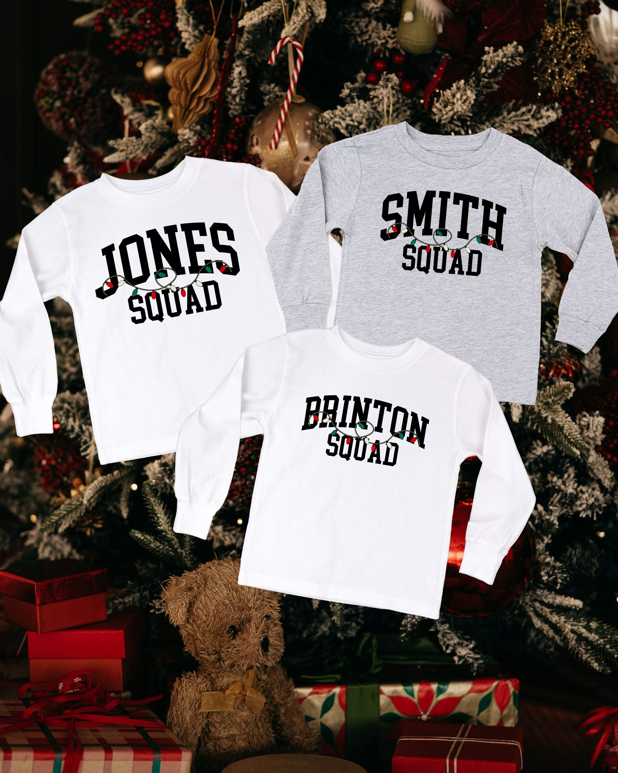 long sleeve in gray and white with personalized last name printed on front with Christmas lights under, shown on flat lay – Little Mama Shirt Shop