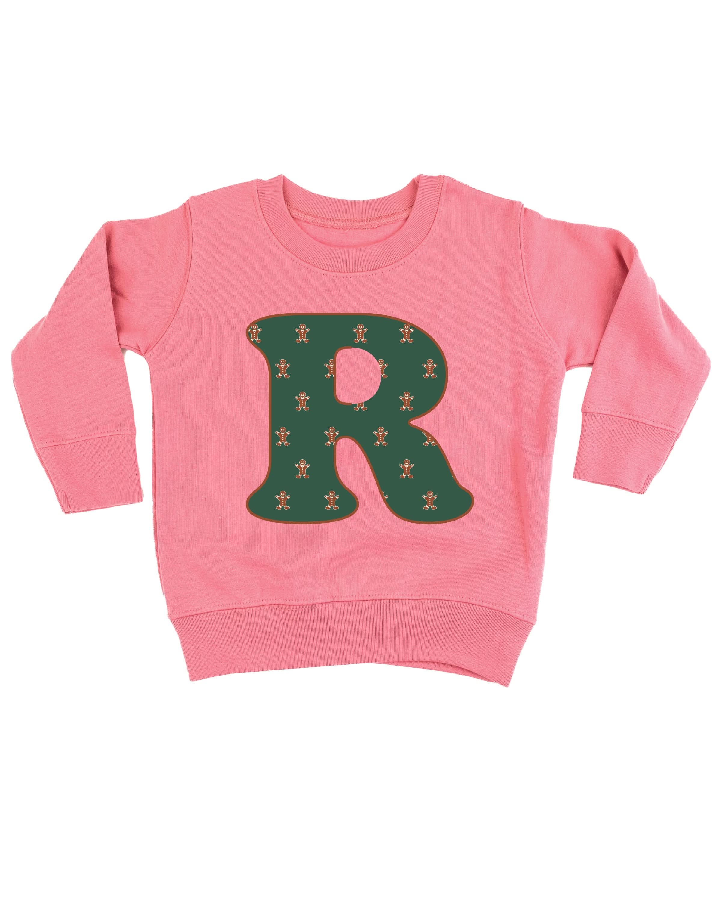 Child sweater in mauvelous with Christmas patterned gingerbread men initial R on front, shown on flat lay – Little Mama Shirt Shop