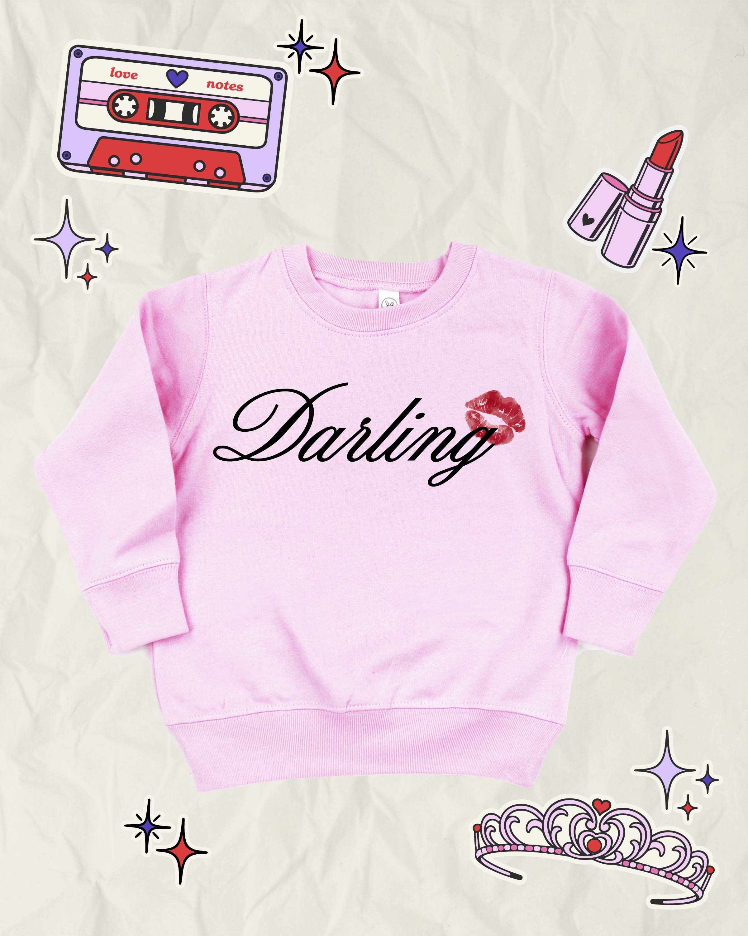 Child pink sweater with "Darling" script and lipstick kiss design, shown on flat lay  – Little Mama Shirt Shop